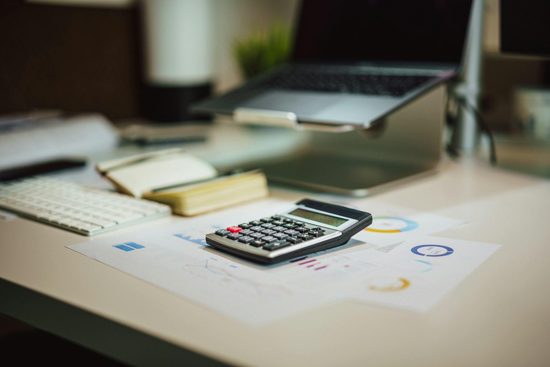Calculator and laptop used for ecommerce financial analysis