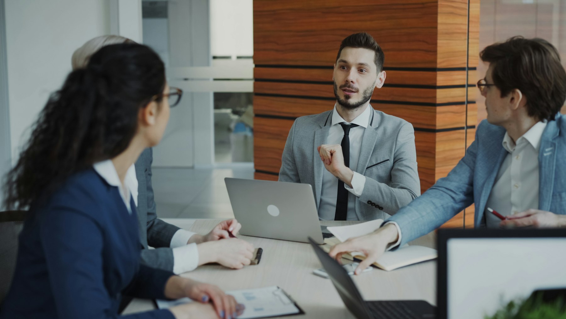 Business discussion around a laptop and report
