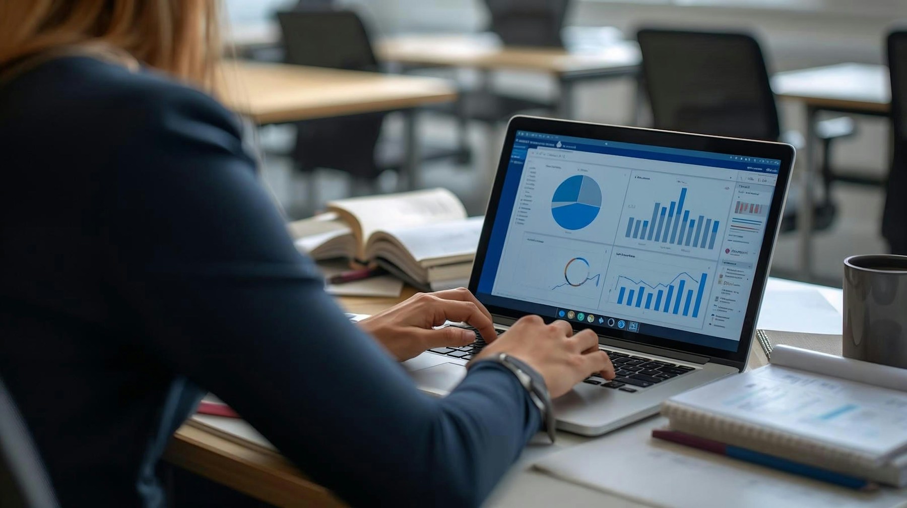 Woman reviewing charts and business analytics on a laptop