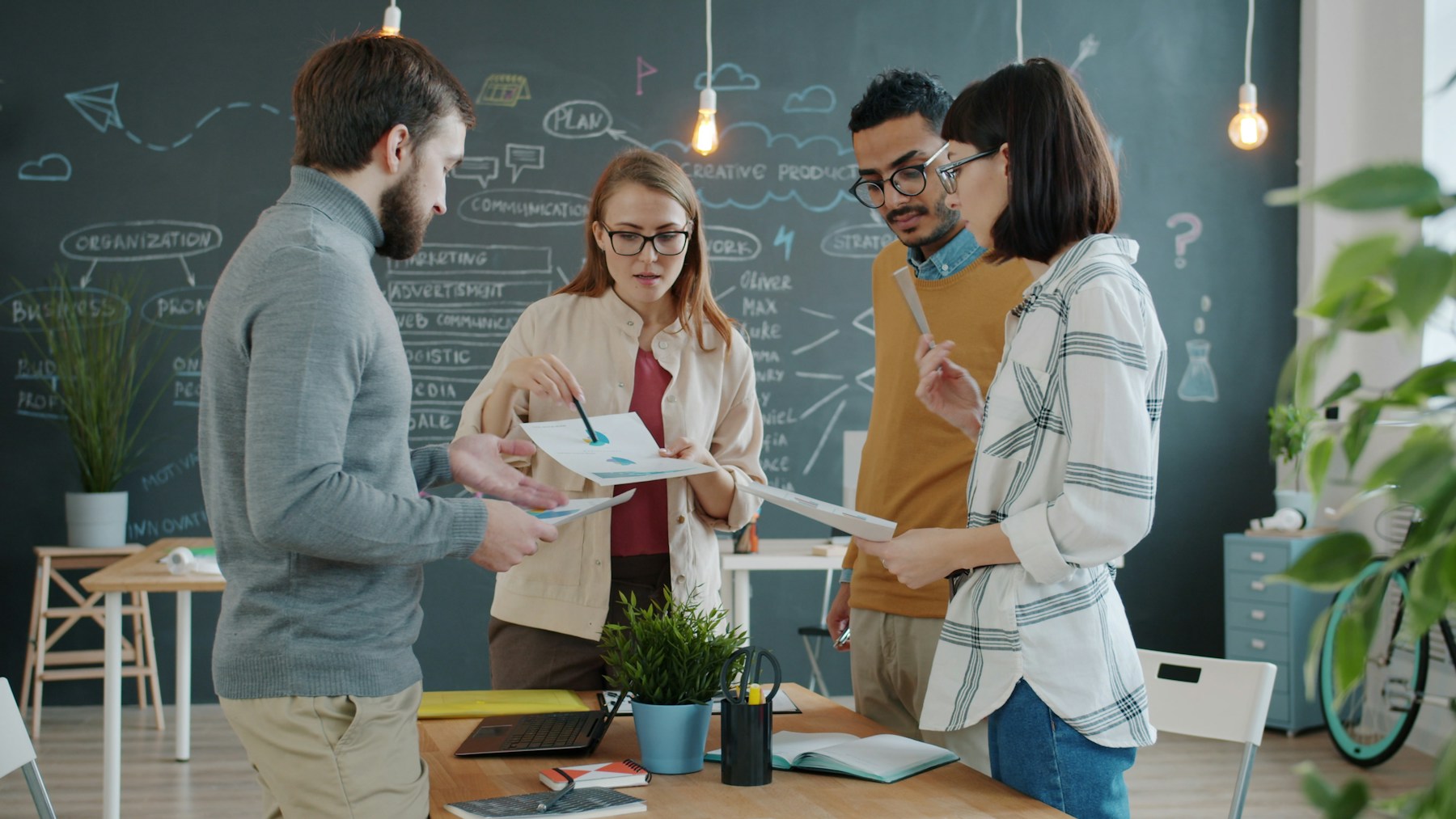 Diverse team collaborating on charts and business data